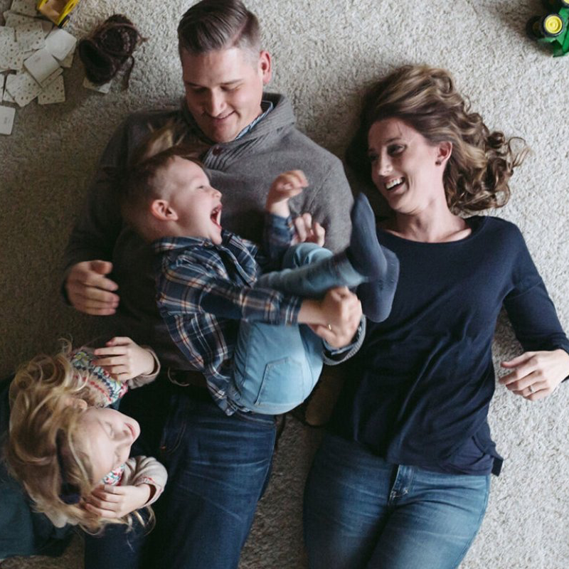 Happy family on the floor McCabe's Quality Flooring in Marquette, MI